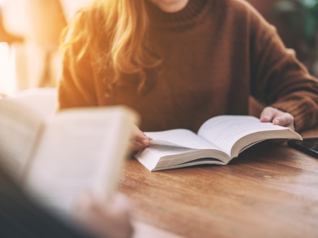 Illustration de l'animation "Lire et revivre" : un livre ouvert posé sur une table, les pages déployées